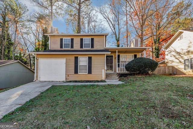 view of property with a garage and a front lawn