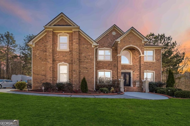 view of front of house with french doors and a yard