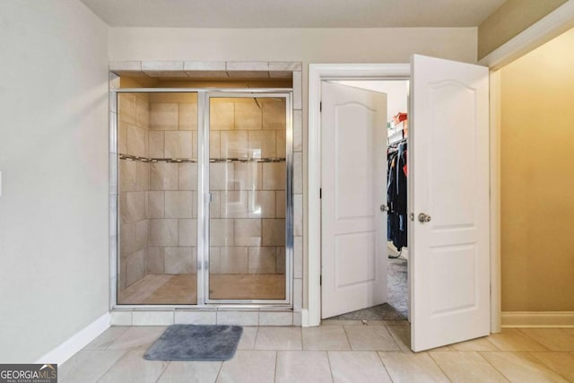 bathroom featuring tile patterned floors and a shower with shower door