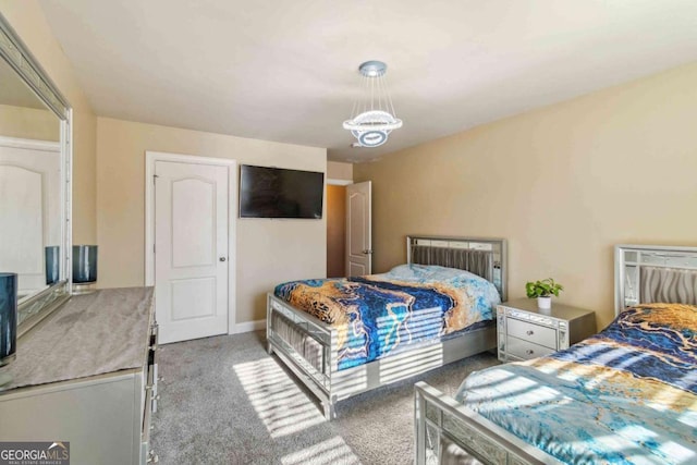 bedroom featuring light colored carpet and a chandelier