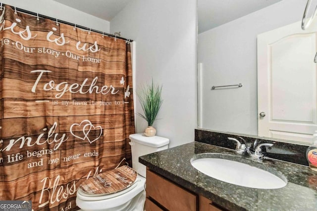 bathroom featuring vanity and toilet