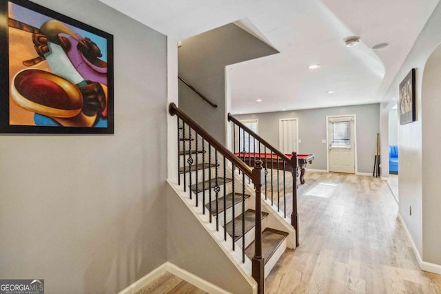 stairs with wood-type flooring