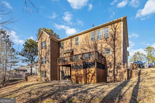 rear view of property with a wooden deck