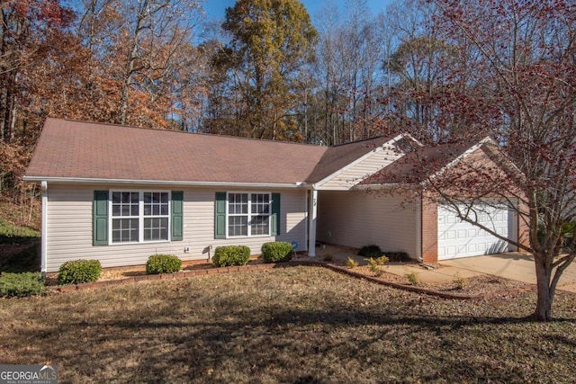 ranch-style house with a garage and a front yard