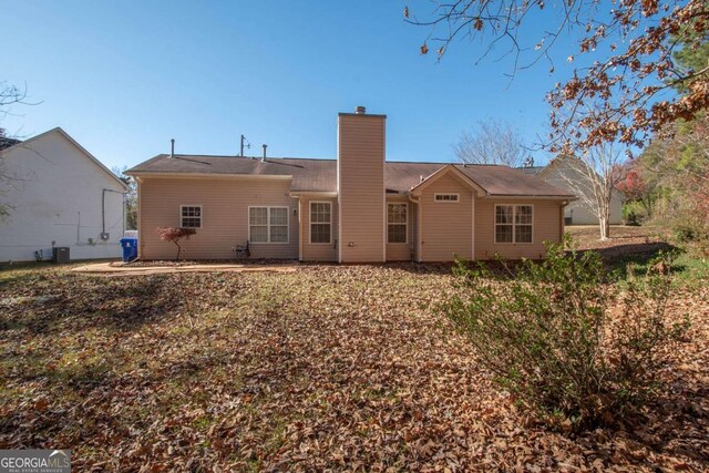 rear view of property with central air condition unit