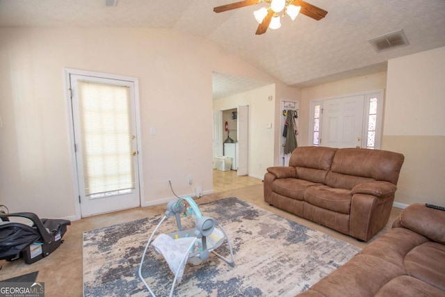 living room with ceiling fan, light colored carpet, plenty of natural light, and lofted ceiling