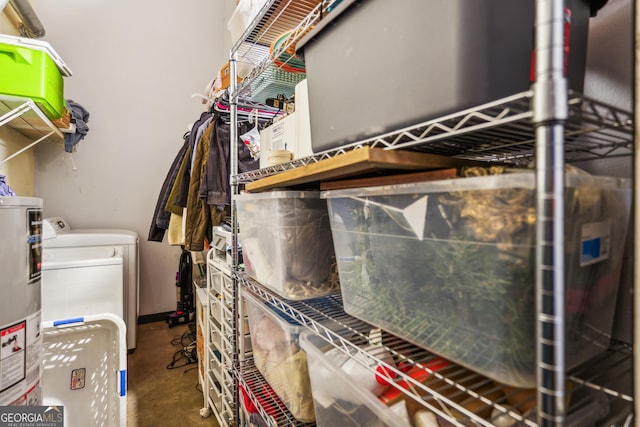 storage room with separate washer and dryer and gas water heater