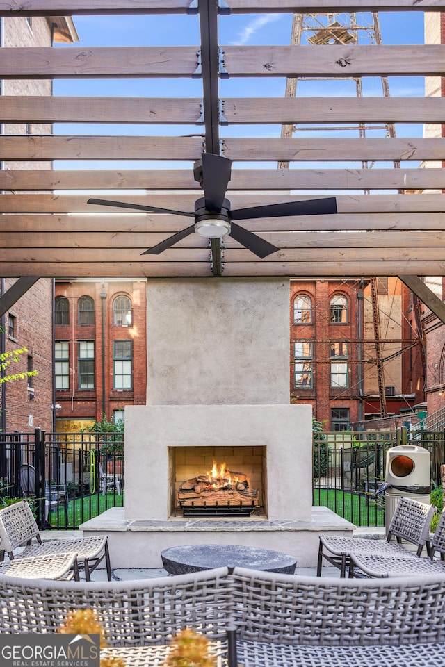 view of patio / terrace featuring ceiling fan and exterior fireplace