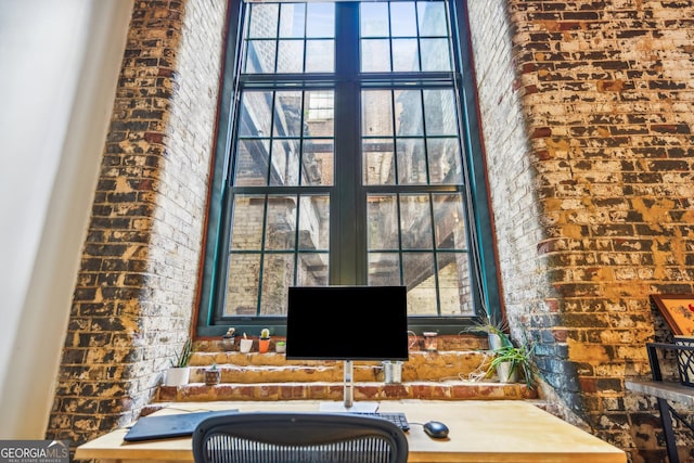 unfurnished office with brick wall