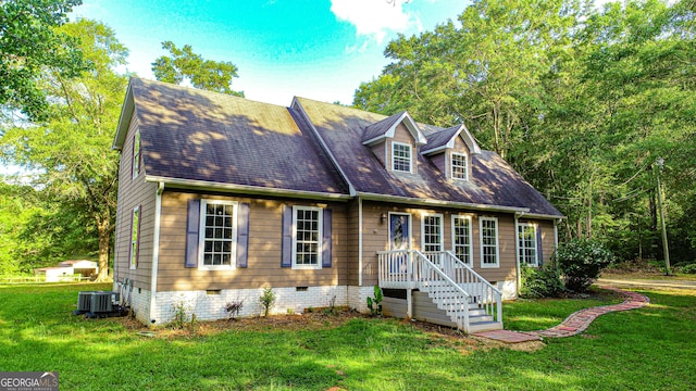 new england style home with central AC unit and a front yard