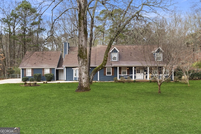 cape cod-style house with a front yard and covered porch