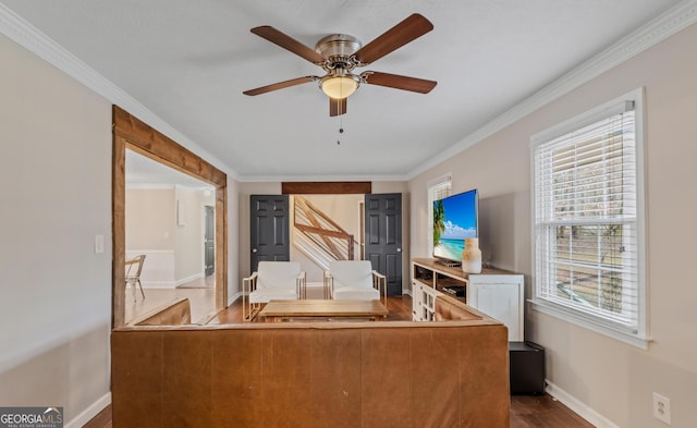 unfurnished living room with hardwood / wood-style flooring, ceiling fan, and crown molding