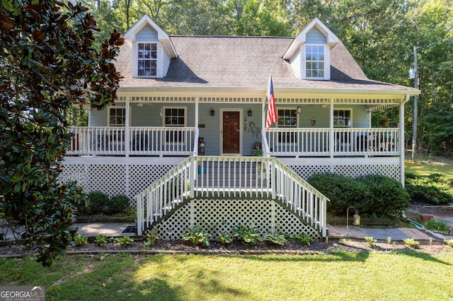 new england style home featuring a front lawn and covered porch