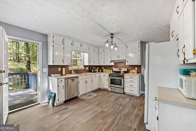 kitchen with white cabinetry, plenty of natural light, stainless steel appliances, and wood-type flooring