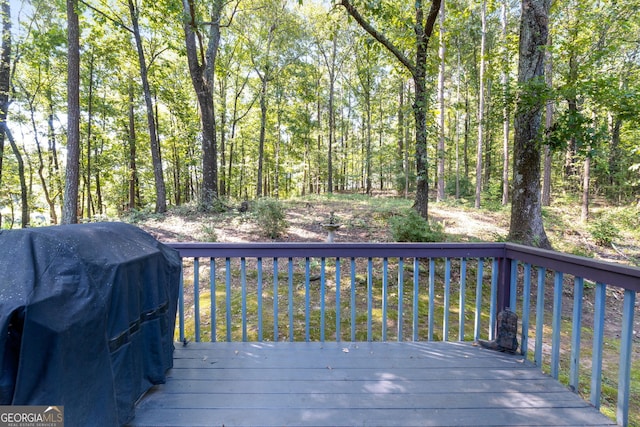 wooden terrace featuring area for grilling