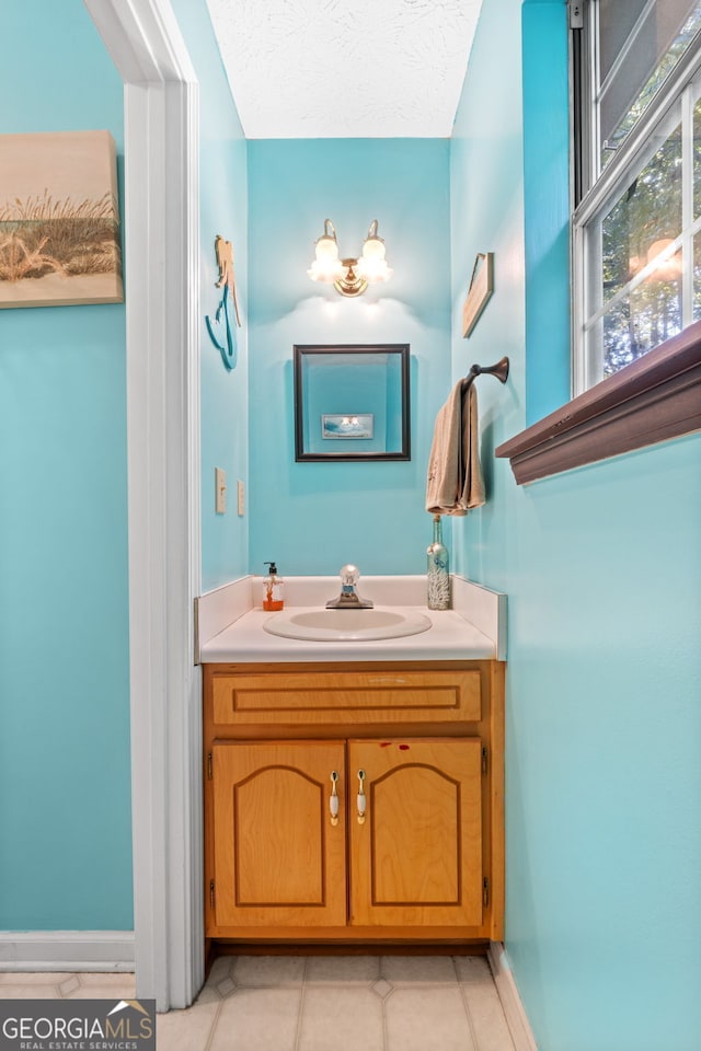 bathroom with vanity and a textured ceiling