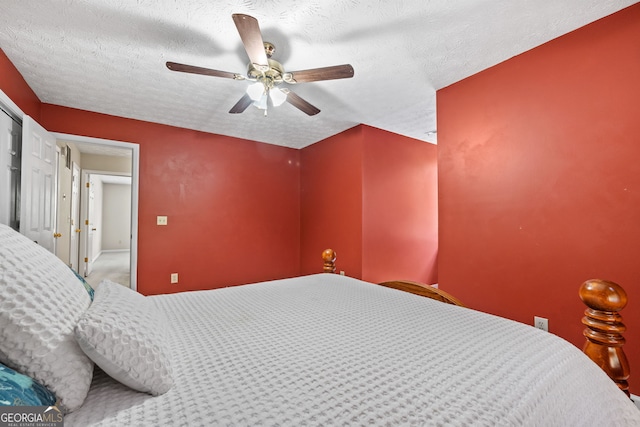 bedroom with a textured ceiling and ceiling fan