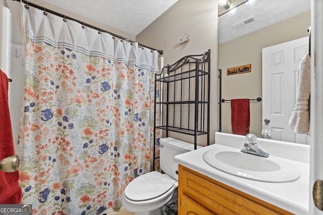 bathroom featuring vanity, a shower with curtain, a textured ceiling, and toilet