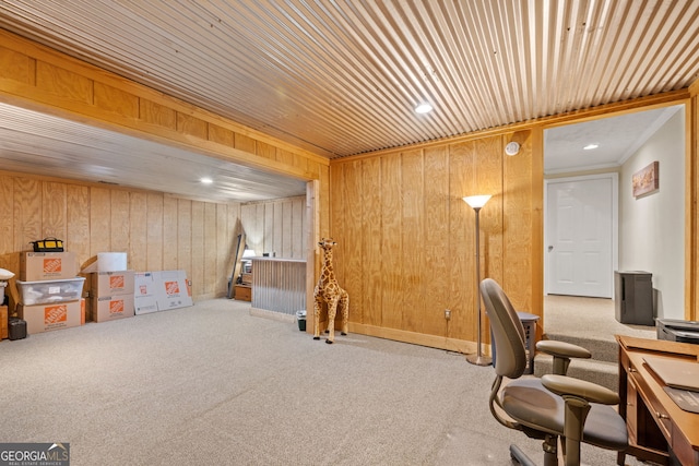 office area featuring wood walls, ornamental molding, and light carpet