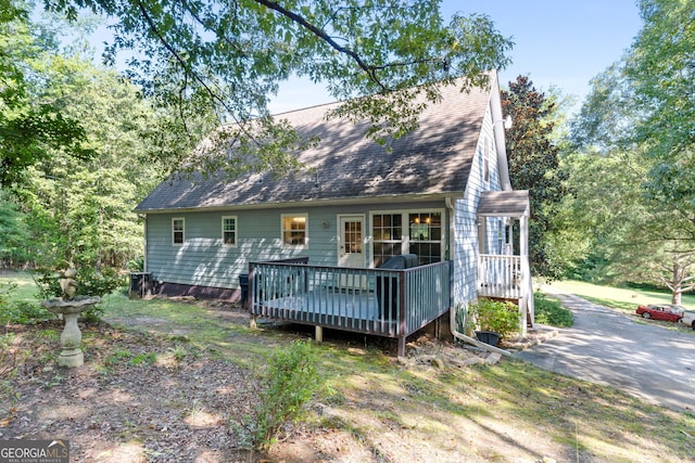 rear view of house featuring a deck