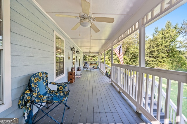 wooden terrace featuring a porch and ceiling fan