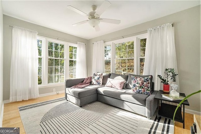 sunroom featuring ceiling fan and a wealth of natural light