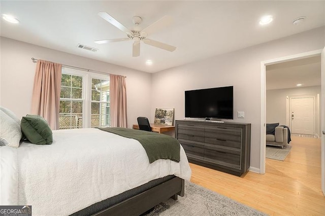 bedroom with ceiling fan and light hardwood / wood-style flooring