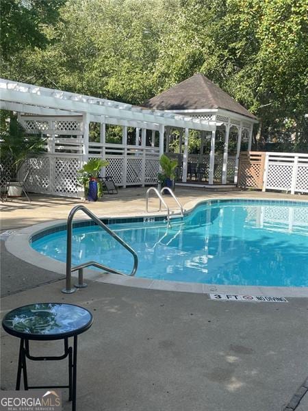 view of swimming pool featuring a gazebo