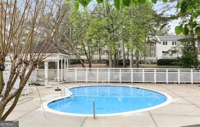 view of swimming pool with a patio area