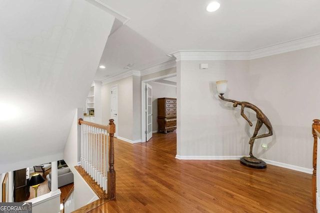 hallway with ornamental molding and hardwood / wood-style flooring