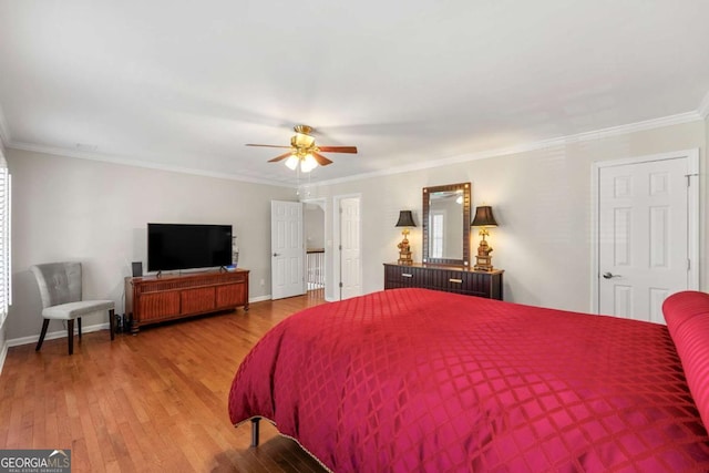 bedroom with ceiling fan, crown molding, and hardwood / wood-style flooring