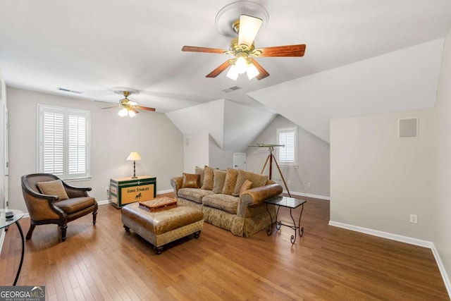 living room featuring ceiling fan, hardwood / wood-style floors, vaulted ceiling, and a healthy amount of sunlight