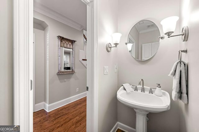 bathroom featuring crown molding and hardwood / wood-style floors