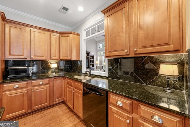 kitchen with black dishwasher, tasteful backsplash, dark stone countertops, crown molding, and sink