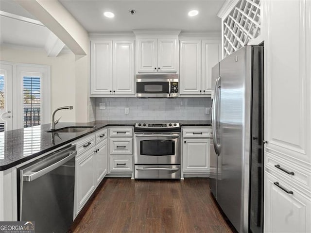 kitchen featuring white cabinetry, appliances with stainless steel finishes, sink, and kitchen peninsula