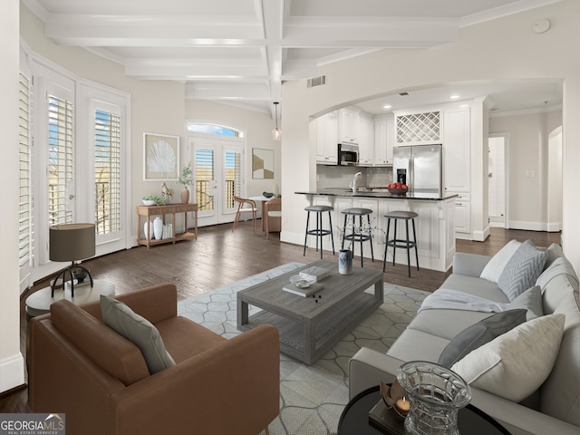 living room with sink, beam ceiling, dark hardwood / wood-style floors, and french doors