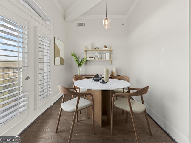 dining room featuring crown molding, dark wood-type flooring, and beam ceiling