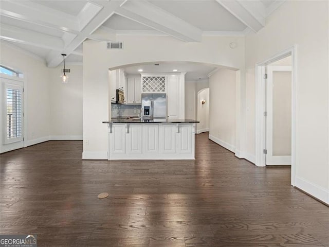 unfurnished living room with beamed ceiling, coffered ceiling, and dark hardwood / wood-style floors