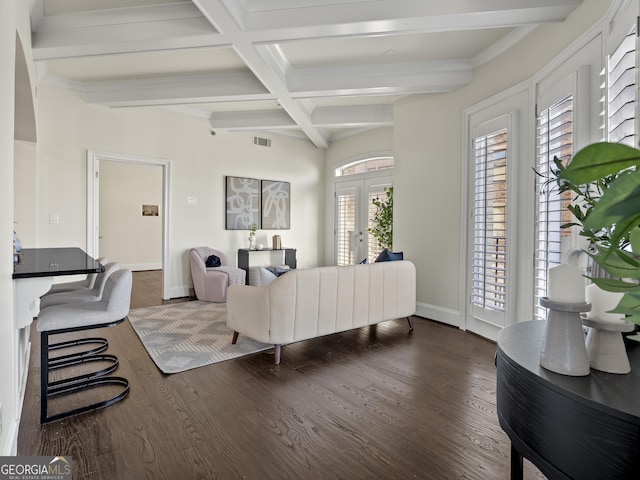 living room featuring dark hardwood / wood-style flooring, beam ceiling, coffered ceiling, and french doors