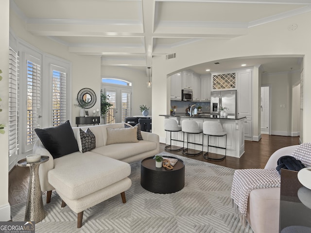 living room with dark hardwood / wood-style flooring, coffered ceiling, french doors, and beamed ceiling