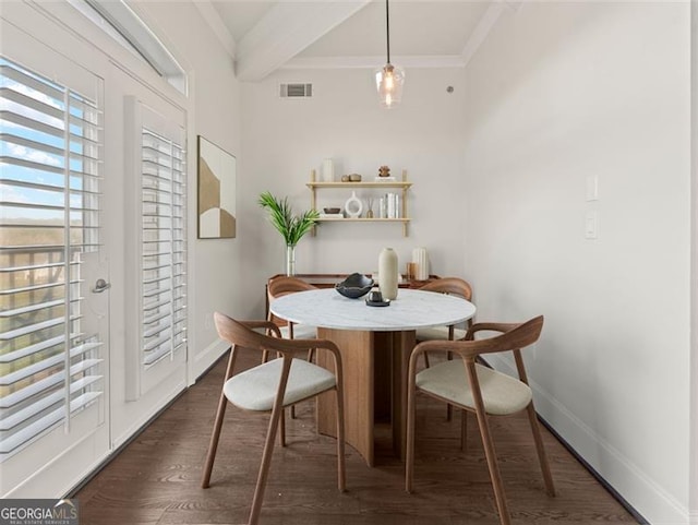 dining room with beamed ceiling, ornamental molding, and dark hardwood / wood-style flooring