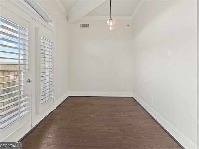 unfurnished dining area with dark wood-type flooring, ornamental molding, and beamed ceiling