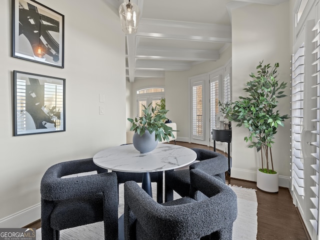 dining space featuring dark wood-type flooring and beam ceiling