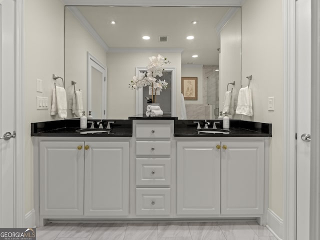 bathroom with ornamental molding, vanity, and an enclosed shower