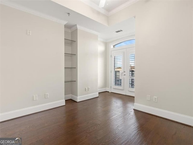 unfurnished room with dark hardwood / wood-style flooring, crown molding, french doors, and built in shelves