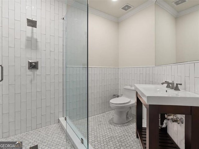 bathroom featuring crown molding, sink, toilet, and walk in shower