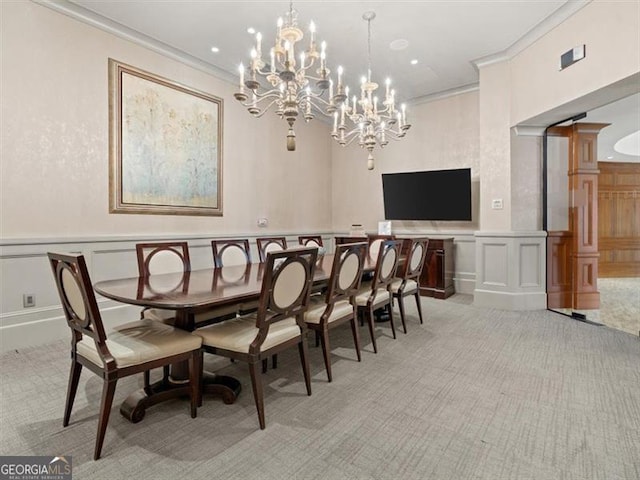 carpeted dining area featuring crown molding and ornate columns