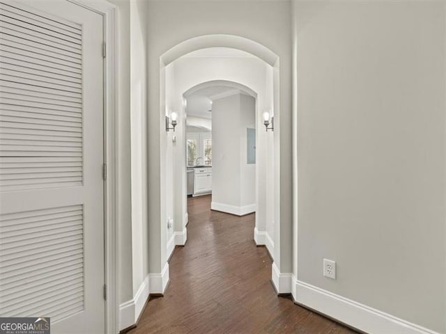 corridor with dark hardwood / wood-style flooring