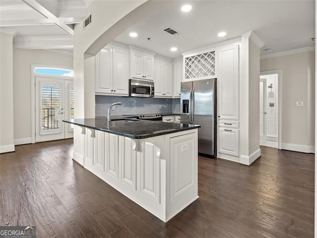 kitchen with a breakfast bar area, stainless steel appliances, dark hardwood / wood-style floors, and white cabinets