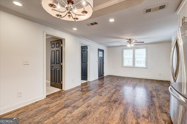 unfurnished living room with ceiling fan with notable chandelier, dark wood-type flooring, and crown molding